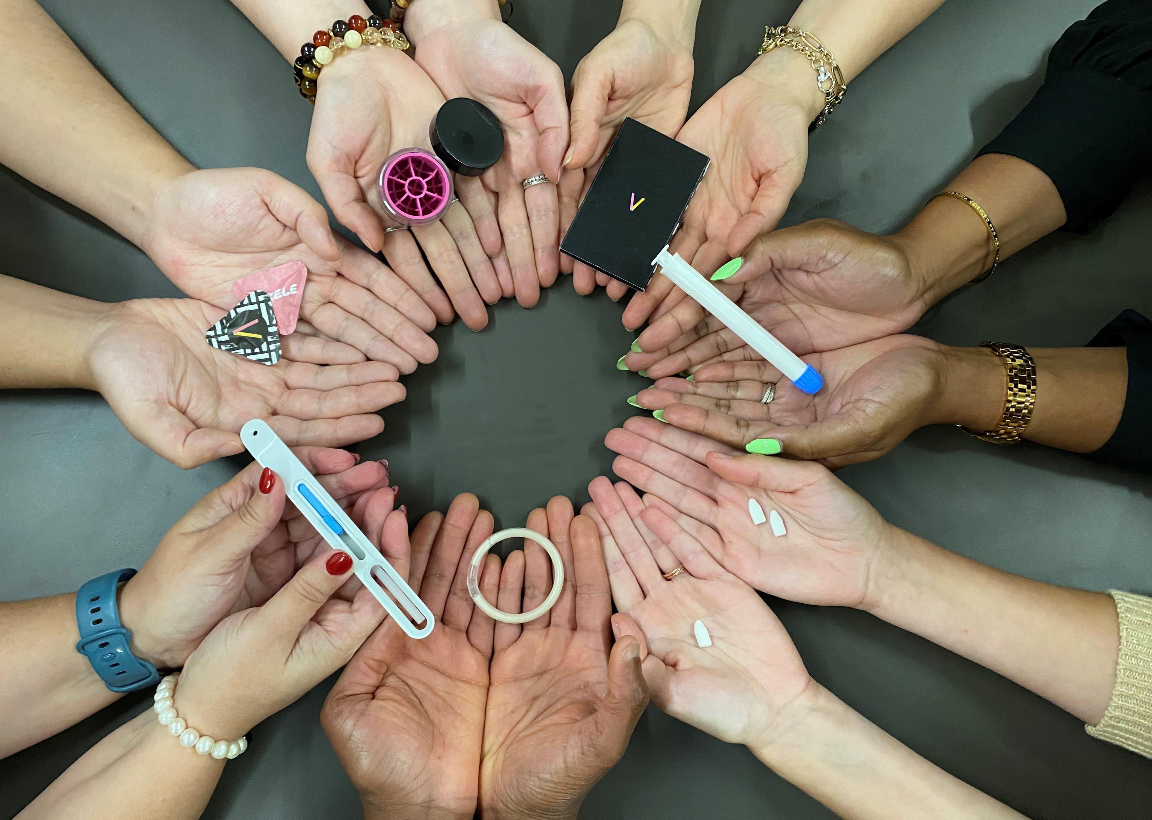 A circle of hands holding medical products