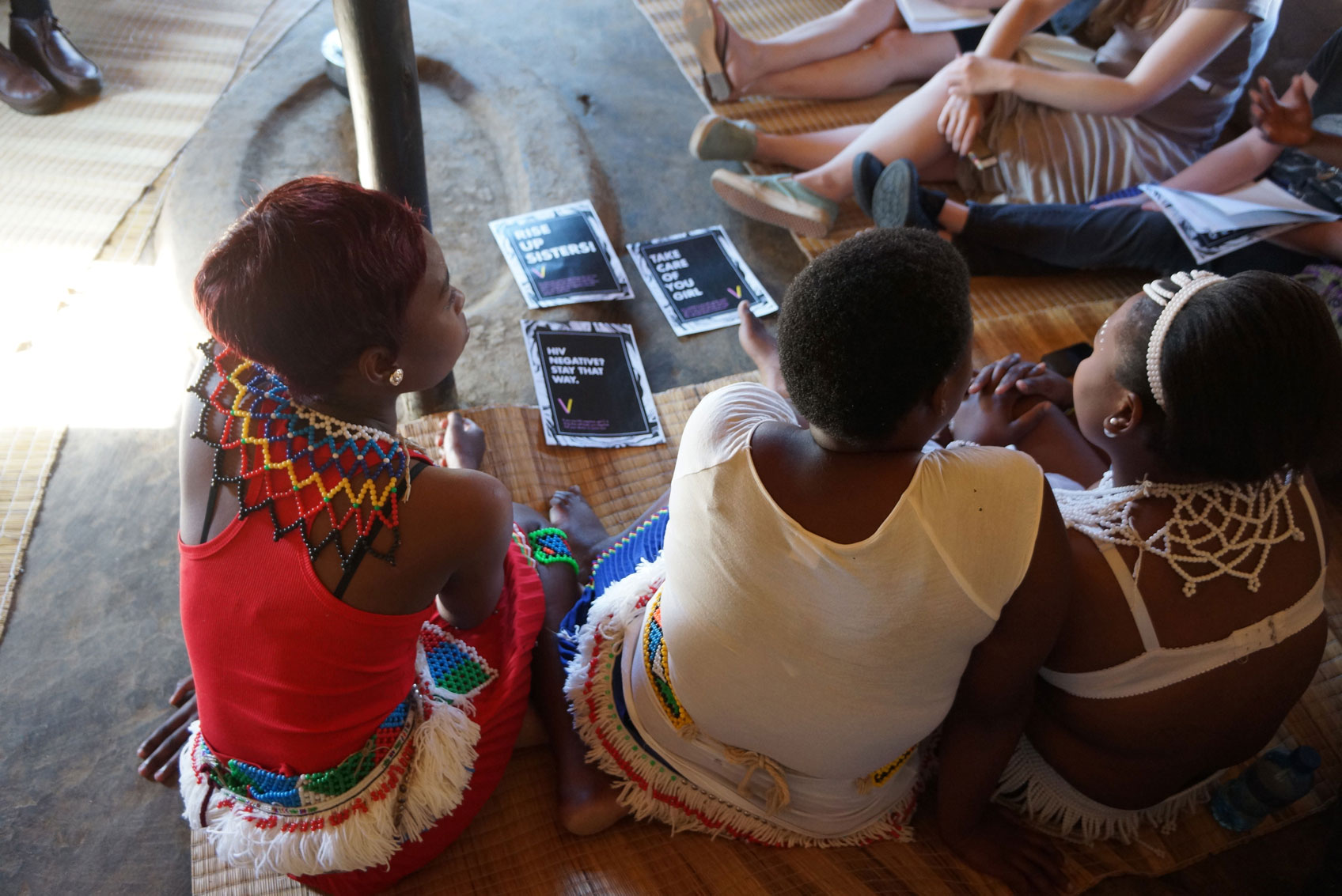 Women sitting on the floor having a discussion.