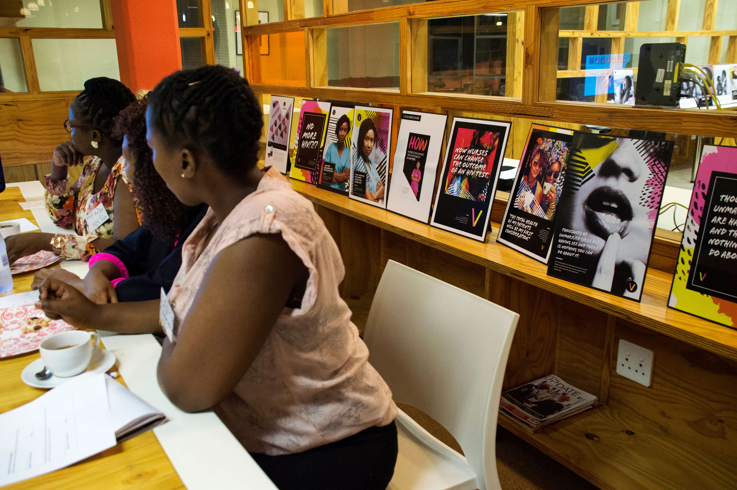 People sitting on desk having a discussion.
